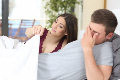 man with erectile dysfunction with her partner looking disappointed