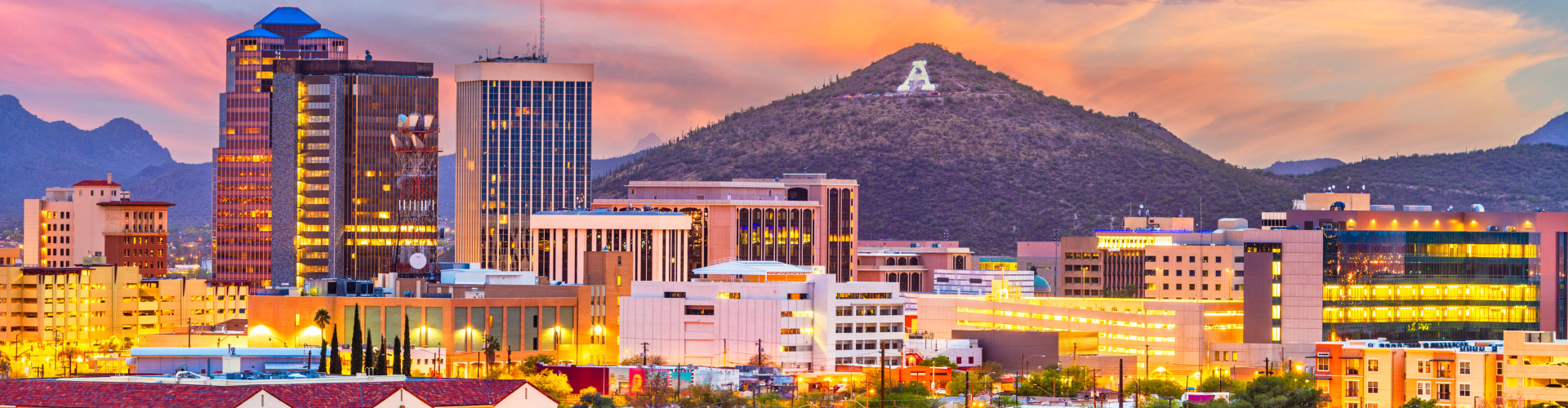 Tucson, Arizona, USA downtown skyline with Sentinel Peak at dusk.